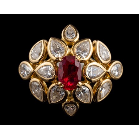 A Ruby And Diamond Ring By Cartier, The Central Oval Cut Ruby